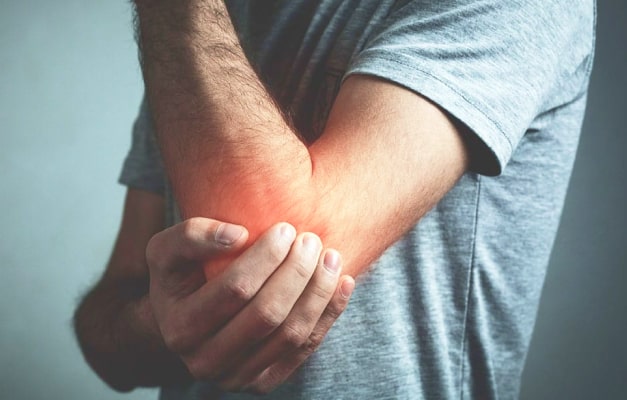 Close up of person with burning pain in elbow