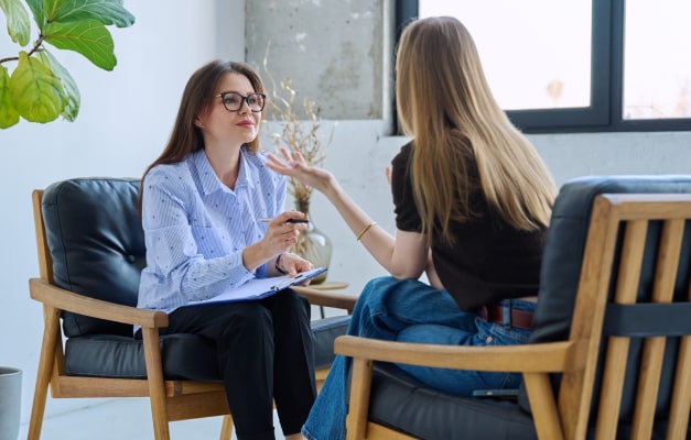 Professional woman consults with patient in a casual office setting