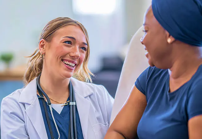 Physician smiling while talking with patient