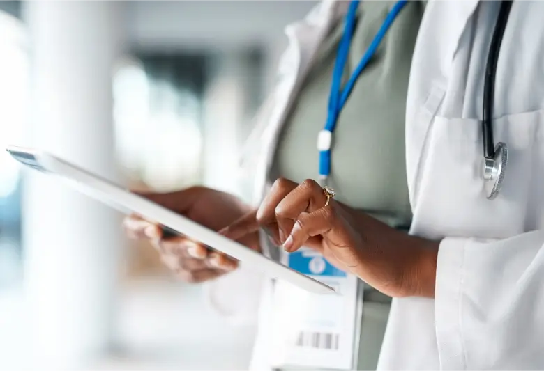Close up of medical professional typing on a tablet