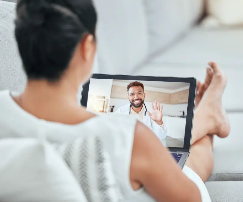 Patient relaxes while on a telemedicine call with a medical professional on a tablet