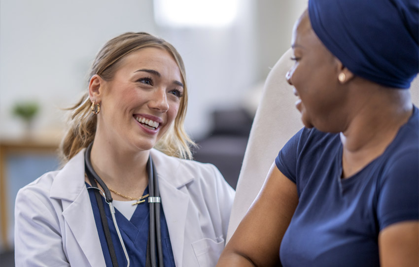 Physician smiling while speaking with a patient