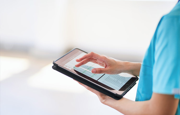 Close up of medical team member using a tablet