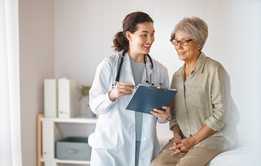 Physician and patient talk while looking at medical chart