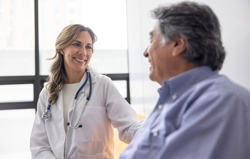 Physician smiling while consulting with a patient