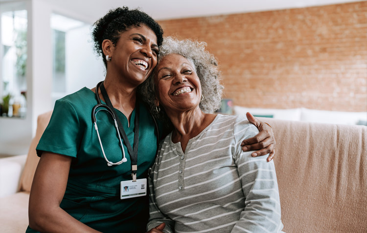 Nurse and patient smiling and embracing