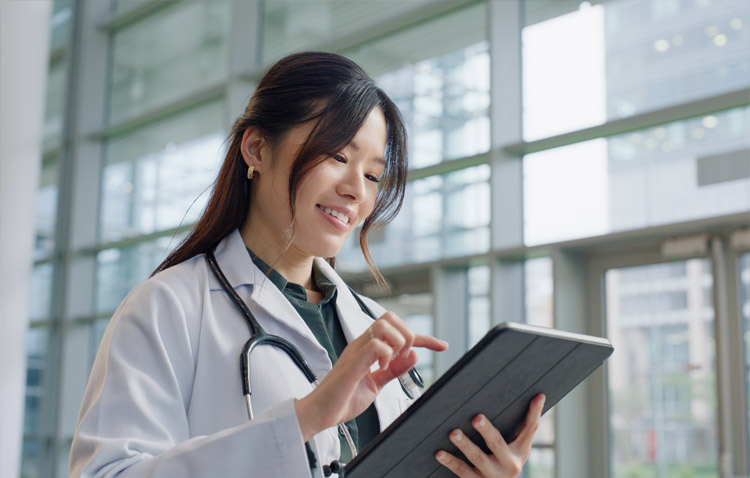 Physician reviewing tablet in office
