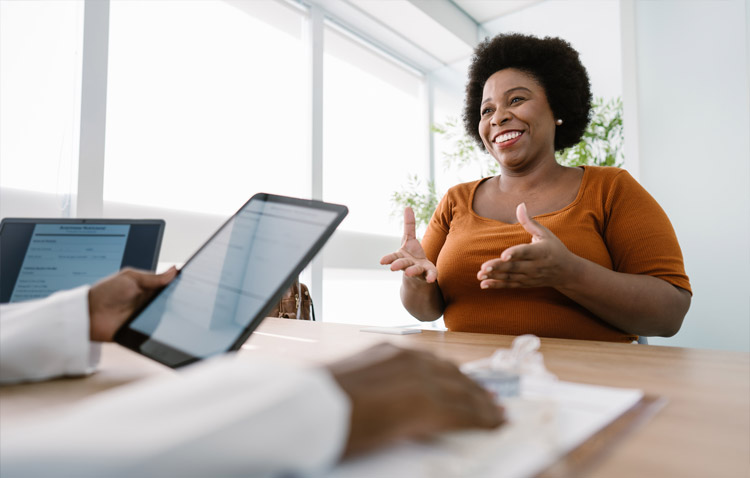 Patient smiling while speaking with a medical professional