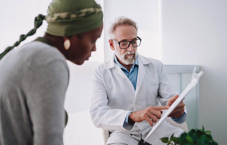 Physician reviews paperwork with a patient