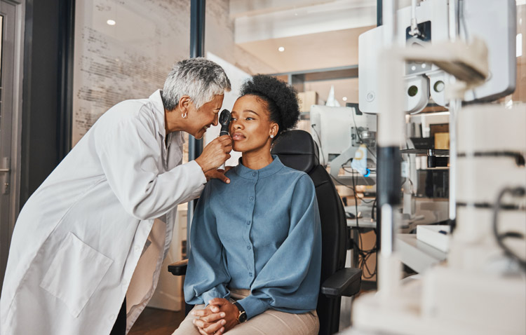Ophthalmologist examines a patient's eye in a medical setting