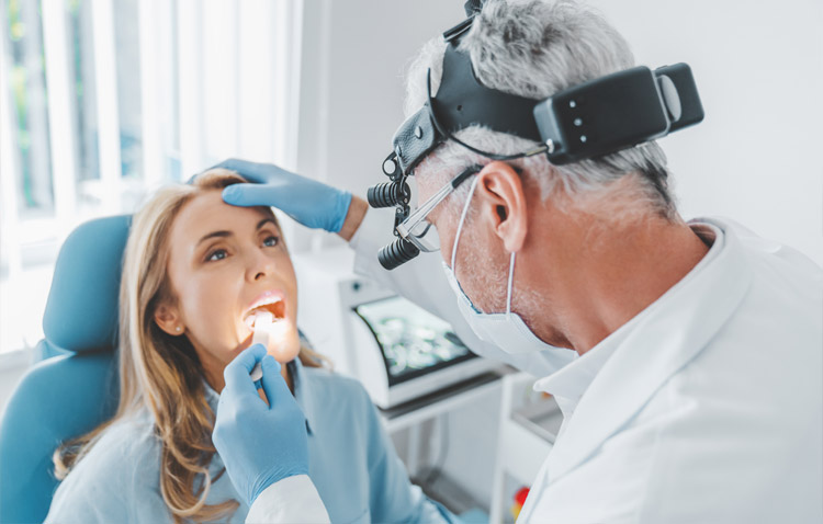 Physician examines a patient's open mouth