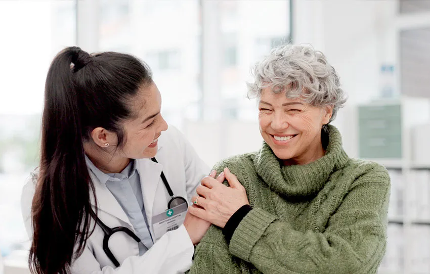 Physician and patient smiling together