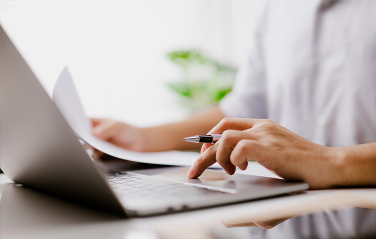 Close up of person typing on a laptop