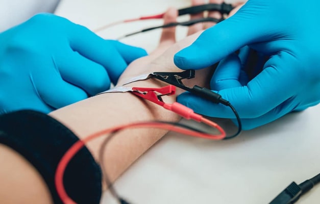 Medical professional attaching electrodes to a patient's wrist