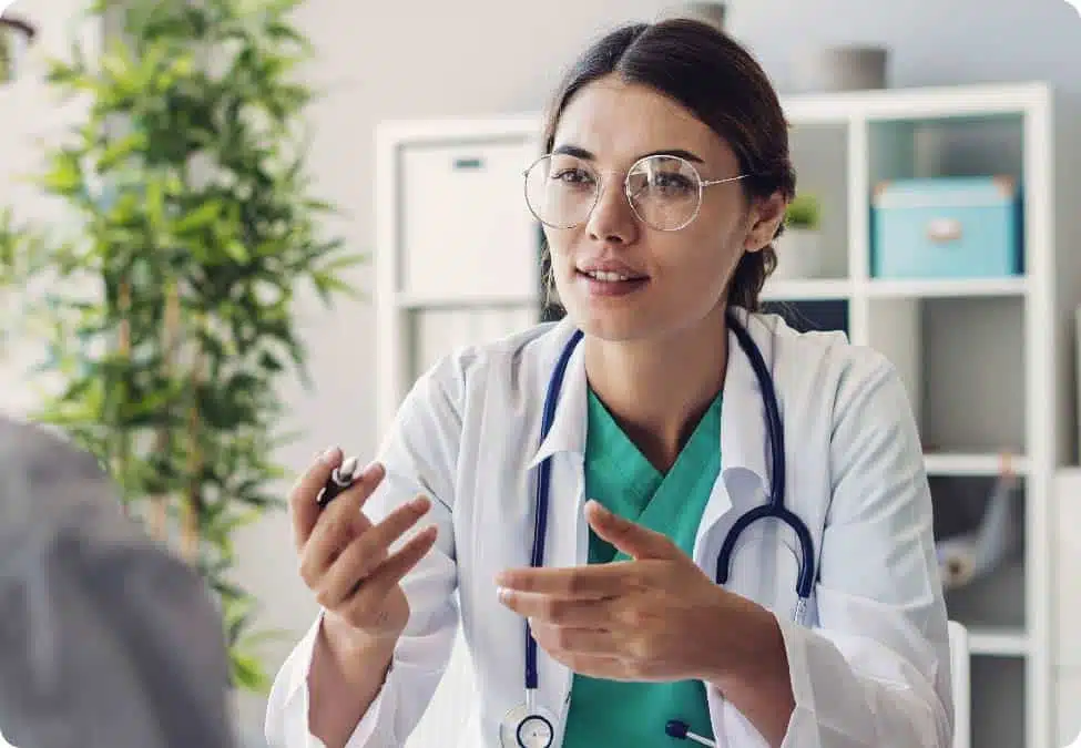 Physician speaking at her desk