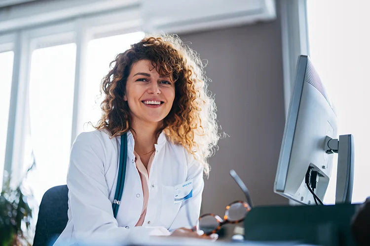 Doctor using cloud-based practice management software to simplify scheduling and patient workflows