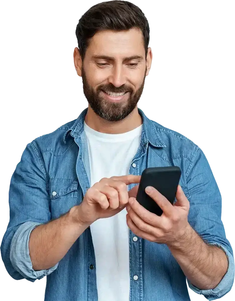 Man smiling while using his mobile phone