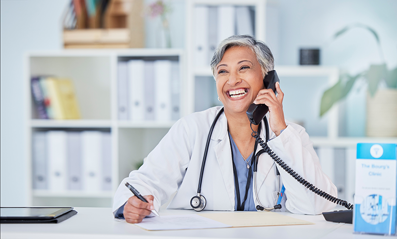 older female doctor on phone